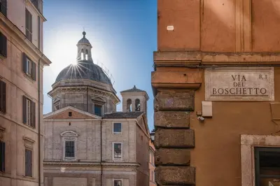 a view of a building with a tower in the distance at Vic Colosseo, Centro Storico Roma in Rome