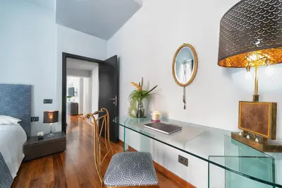 a bedroom with a desk and a bed and a mirror at Vic Colosseo, Centro Storico Roma in Rome