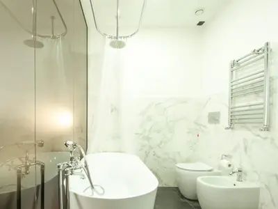 a bathroom with a tub and a sink and a toilet at Holidays Suites Navona in Rome