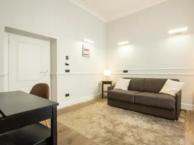 a living room with a couch and a table at Holidays Suites Navona in Rome