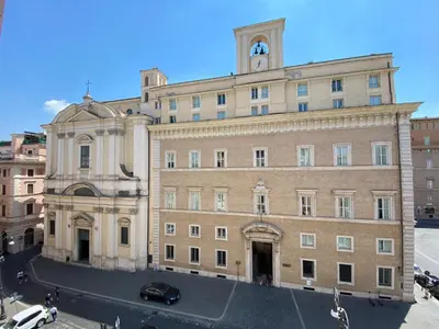 a large brick building with a clock tower on top at Holidays Suites Navona in Rome