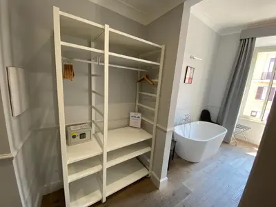 a bathroom with a walk in shower and a bath tub at Holidays Suites Navona in Rome