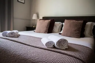 a bed with towels sitting on top of it at Holidays Suites Navona in Rome