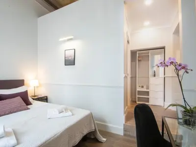 a bedroom with a bed and a glass table at Gemini Suites Navona in Rome