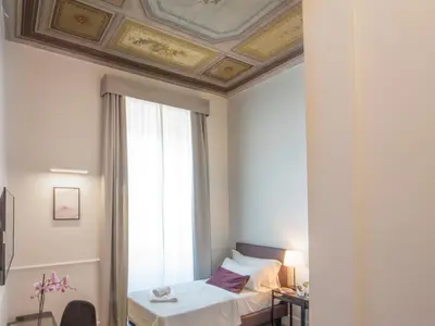 a hotel room with a bed and a window at Gemini Suites Navona in Rome