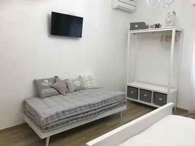 a living room with a couch and a mirror at Da Nonna Maria in Rome