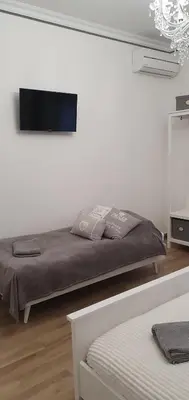 a bedroom with a bed and a flat screen tv at Da Nonna Maria in Rome