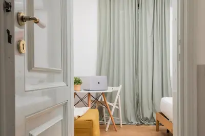 a bedroom with a desk with a laptop computer on it at Trevi Fountain Apartment - ZENO 03 in Rome