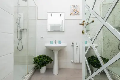 a white bathroom with a sink and a shower at Trevi Fountain Apartment - ZENO 03 in Rome