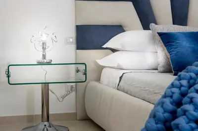 a bed room with a glass table next to a bed at St.Peter's Eden in Rome