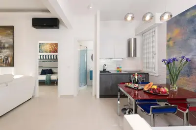 a kitchen and living room with a table and chairs at St.Peter's Eden in Rome