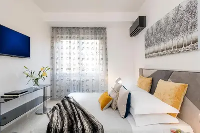 a bedroom with a bed and a tv at St.Peter's Eden in Rome