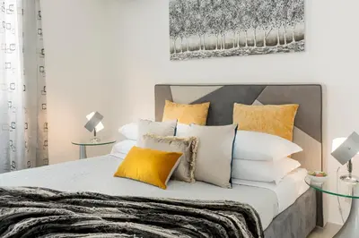 a bedroom with a bed with white and yellow pillows at St.Peter's Eden in Rome