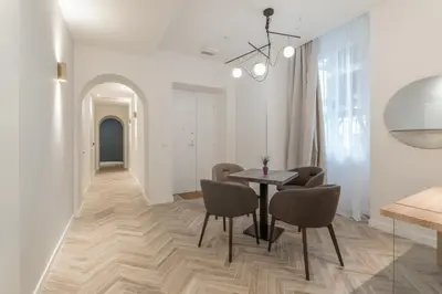 a dining room with a table and chairs and a hallway at Florea Palace in Rome