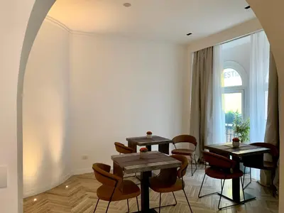 a room with two tables and chairs and a window at Florea Palace in Rome
