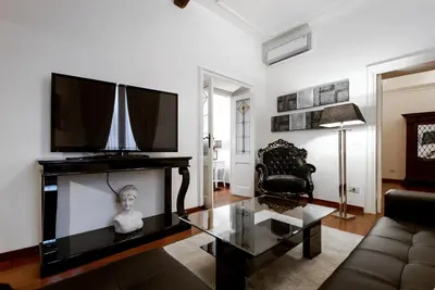 a living room with a tv and a couch at Easydomus Rome in Rome