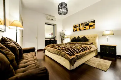 a bedroom with a bed and a couch at Easydomus Rome in Rome