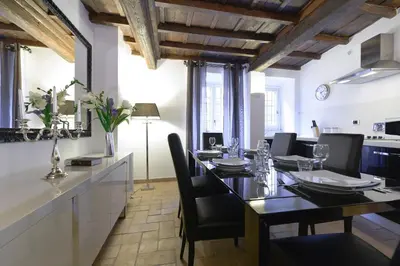 a dining room with a long table and chairs at Easydomus Rome in Rome