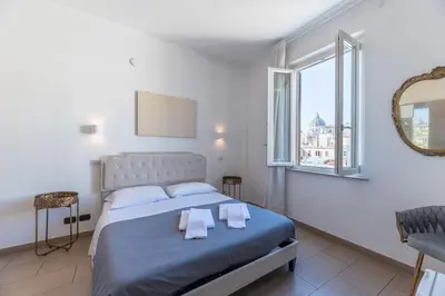 a bedroom with a bed with towels on it at Art Atelier Vaticano Guest House in Rome