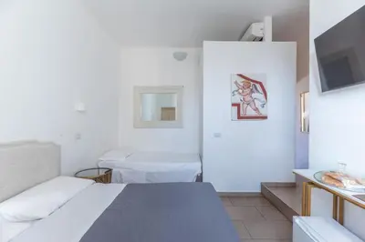 a hospital room with two beds and a television at Art Atelier Vaticano Guest House in Rome
