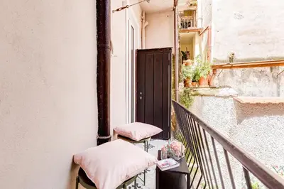 a balcony with two chairs and a table at Tankara Suite in Rome