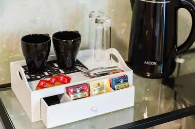 a shelf with coffee cups and a blender on a table at Tankara Suite in Rome