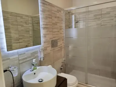 a bathroom with a sink and a toilet and a shower at Almachiara in Rome