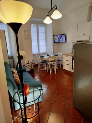 a living room with a table and a floor lamp at Almachiara in Rome