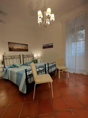 a bedroom with a bed and a table and chairs at Almachiara in Rome