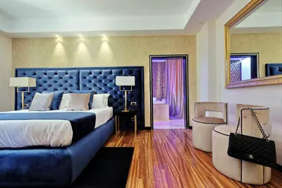 a bedroom with a large bed and a couch at Spanish Diamond Luxury Suites & Jacuzzi in Rome