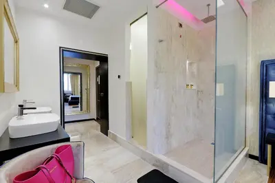 a bathroom with a sink and a glass shower at Spanish Diamond Luxury Suites & Jacuzzi in Rome