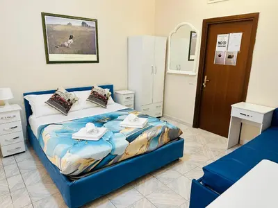 a bedroom with a blue bed with towels on it at welcome Termini in Rome