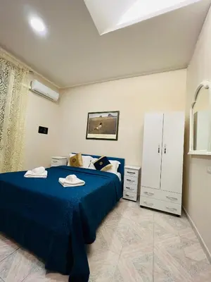 a bedroom with a blue bed in a room at welcome Termini in Rome