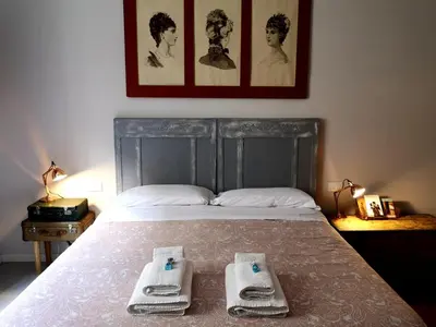 a bedroom with a bed with two towels on it at Interno Otto in Rome