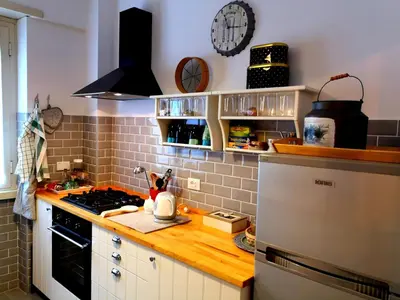 a kitchen with a stove and a clock on the wall at Interno Otto in Rome