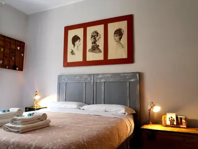 a bedroom with a bed with a picture on the wall at Interno Otto in Rome
