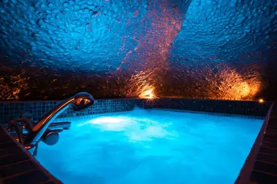 a bath tub with lights in a dark room at SuiteFrattini Private Spa in Rome