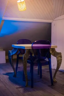 a table with two chairs and a purple table at SuiteFrattini Private Spa in Rome