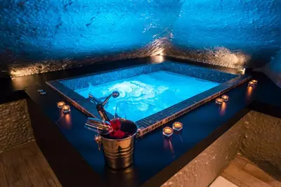a pool of blue water with a fork in a bucket at SuiteFrattini Private Spa in Rome