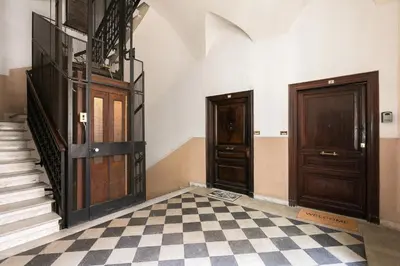 a hallway with two doors and a checkered floor at VENETO AVENUE in Rome