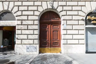 a large wooden door in a stone building at VENETO AVENUE in Rome