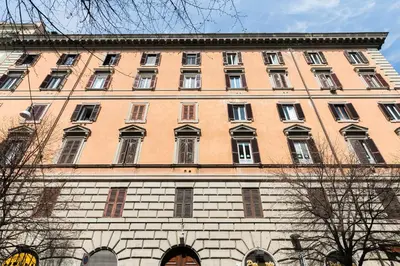 a large brick building with many windows on it at VENETO AVENUE in Rome