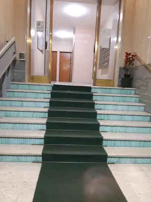 a staircase in a building with green and blue steps at Roma Apartment in Rome