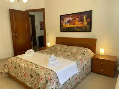 a bedroom with a bed with two towels on it at Roma Apartment in Rome