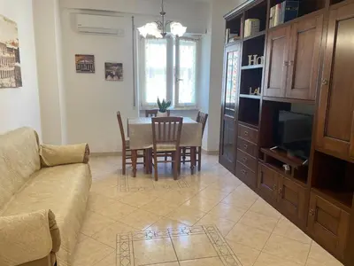 a living room with a couch and a dining room table at Roma Apartment in Rome