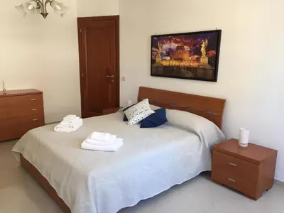 a bedroom with a bed with two towels on it at Roma Apartment in Rome