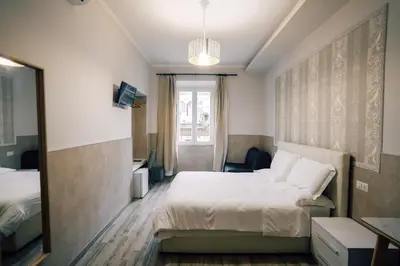 a hotel room with a bed and a mirror at Walker Rooms in Rome