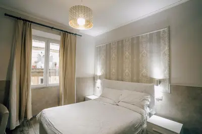 a bedroom with a white bed and a window at Walker Rooms in Rome
