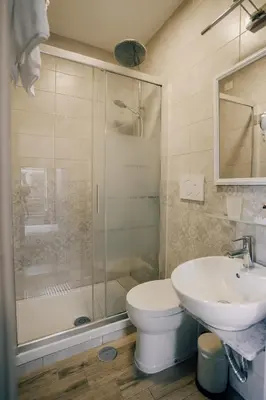 a bathroom with a shower and a toilet and a sink at Walker Rooms in Rome