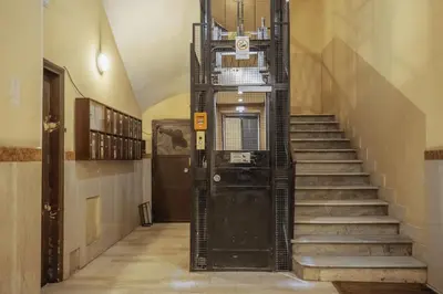 a staircase with a black door in a building at Walker Rooms in Rome